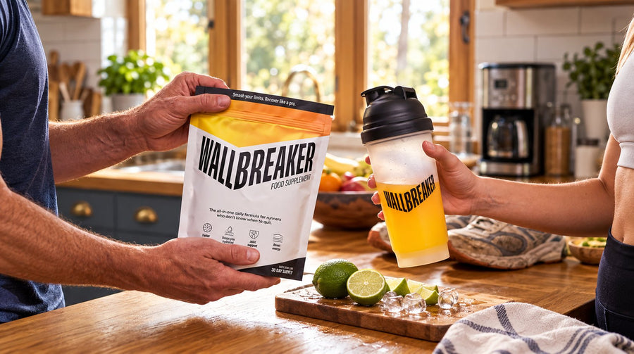 Wallbreaker pouch and orange drink in a branded shaker beside lime and ice